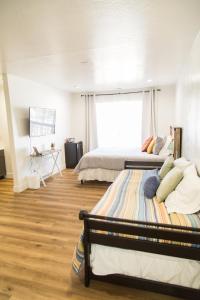 a bedroom with two beds and a large window at Happy Trails BnB in Tropic