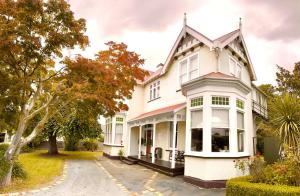 una gran casa blanca con muchas ventanas en The Vicarage Boutique Bed and Breakfast Oamaru en Oamaru