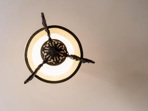 aendant light hanging on a white wall at Chateau d'Angkor La Residence in Siem Reap