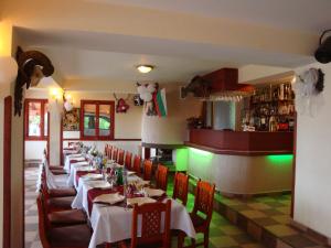 a row of tables in a restaurant with green lights at Family Hotel Diana in Lyaskovo