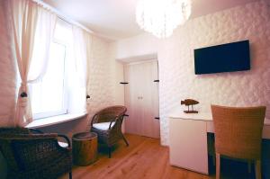 a room with chairs and a desk and a window at Boutique Hotel Placa in Krk