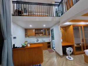 a kitchen with a staircase in a house at Sunmay Villa Tam Dao - Venuestay in Vĩnh Phúc