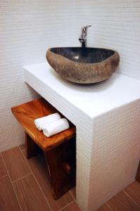a bathroom with a stone sink on a counter at Boutique Hotel Placa in Krk