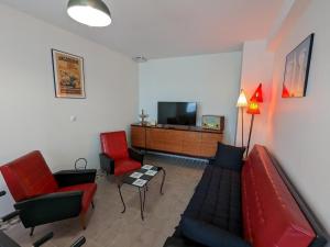 a living room with a couch and chairs and a tv at Gîte Vars, 4 pièces, 6 personnes - FR-1-653-16 in Vars