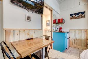 a kitchen with a wooden table and a blue refrigerator at Tahoe Mountain Inn in South Lake Tahoe