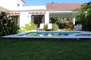 a swimming pool in front of a house at Villa Luce in Las Terrenas