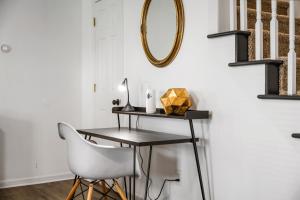 a table and a chair in a room with a mirror at DTPrivacy*KidsFriendly*PetFriendly*300M*Walkable in Raleigh