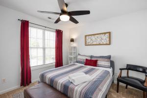 a bedroom with a bed and a ceiling fan at DTPrivacy*KidsFriendly*PetFriendly*300M*Walkable in Raleigh