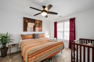 a bedroom with a bed and a ceiling fan at DTPrivacy*KidsFriendly*PetFriendly*300M*Walkable in Raleigh