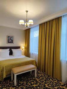 A bed or beds in a room at Abakan Hotel