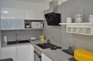 a small kitchen with a sink and a microwave at Apartment Beautifull View in Rabac