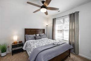 a bedroom with a bed and a ceiling fan at DTGem-SelfCheckin-RainShower-300M-Parking-Walkable in Raleigh
