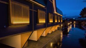 a building with lights on the side of it at night at HOTEL ZEN-Adult Only in Hirosaki