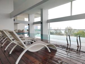 a group of chairs sitting on a wooden floor in a building at Gurney Duplex / 2bedrooms / 8pax in George Town