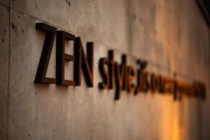 a sign for the american sign company on a wall at HOTEL ZEN-Adult Only in Hirosaki