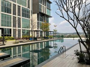 a large building with a swimming pool in front of it at 3Element*CornerUnit*Goodview* *NSK*Aeon*wifi in Seri Kembangan