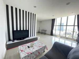 a living room with a flat screen tv and a table at 3Element*CornerUnit*Goodview* *NSK*Aeon*wifi in Seri Kembangan