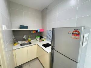 a small kitchen with a refrigerator and a sink at 3Element*CornerUnit*Goodview* *NSK*Aeon*wifi in Seri Kembangan