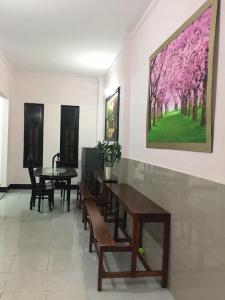 a dining room with a table and a painting on the wall at Homestay 484 in Pleiku