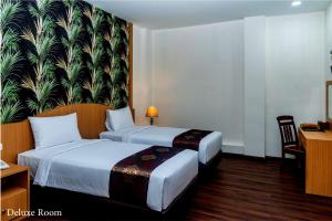 Postel nebo postele na pokoji v ubytování Grand Bayu Hill Hotel + 31 fotografií