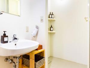 a bathroom with a sink and a mirror at Nara Guesthouse 3F in Nara