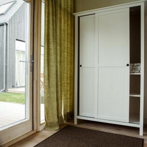 a door leading into a room with a window at Domi Lini in Druskininkai
