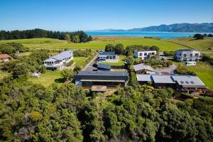 an aerial view of a house on a hill near the water at On The Edge in Kaikoura