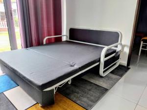 a hospital bed sitting in a room next to a window at Tamu Homestay Terengganu in Kuala Terengganu