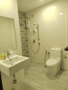 a bathroom with a sink and a shower and a toilet at Gurney Duplex / 2bedrooms / 8pax in George Town