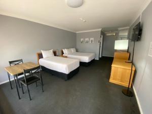 Postel nebo postele na pokoji v ubytování Old Maitland Inn - Rutherford