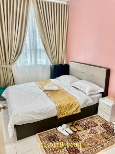 a bedroom with a bed with shoes on the floor at Alaghapoo Service Apartment Near Drawbridge in Kuala Terengganu