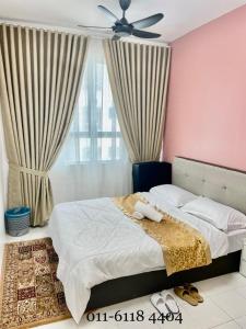 a bedroom with two beds and a ceiling fan at Alaghapoo Service Apartment Near Drawbridge in Kuala Terengganu