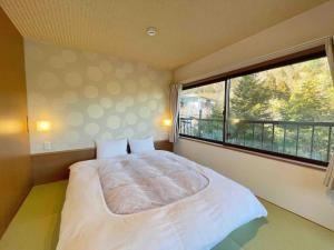 Una cama o camas en una habitación de 雅・小涌谷　温泉別荘　Miyabi Kowakudani Hopspring Villa