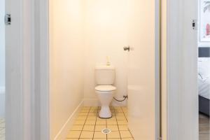 a bathroom with a toilet in a room at Driftwood Cottage 1 28 Farm Rd pet friendly Wi Fi Air Con and ground floor in Fingal Bay +28 photos