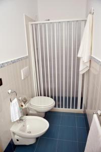 a bathroom with a toilet and a sink at B&B Colori del Salento in Presicce