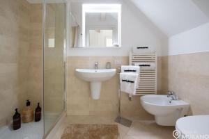 a bathroom with a sink and a toilet and a shower at MURANO Place - FILIGRANA House in Murano