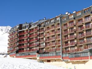 a large building with snow in front of it at LCB Apartaments Pas de la Casa in Pas de la Casa