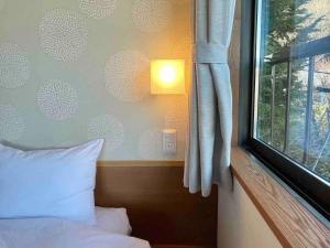 Una cama o camas en una habitación de 雅・小涌谷　温泉別荘　Miyabi Kowakudani Hopspring Villa