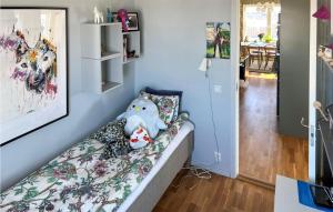 a teddy bear sitting on a couch in a room at 3 Bedroom Lovely Apartment In Uppsala in Uppsala +2 photos
