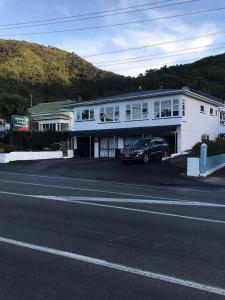 a black car parked in front of a white building at Admirals Lodge in Picton
