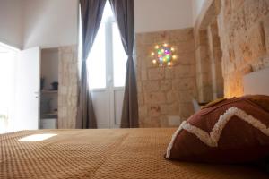 A bed or beds in a room at Apulian House