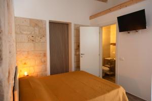 A bed or beds in a room at Apulian House