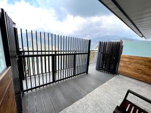 a balcony with a view of the ocean with a fence at Cloud Villa in Hualing