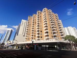 a large building on a street with tall buildings at Surfers Private Apartments in Gold Coast