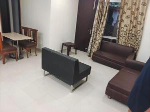 a waiting room with couches and a table and chairs at Just Naturals Wellness Resort Nainital in Bhowāli +69 photos