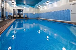 a large swimming pool with blue tiles on the wall at Holiday Inn Louisville Airport South, an IHG Hotel in Louisville