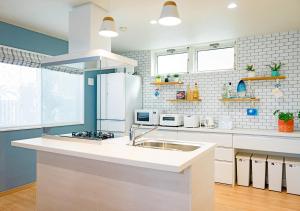 A kitchen or kitchenette at Villa Malibu Palm Springs Miyakojima Resort