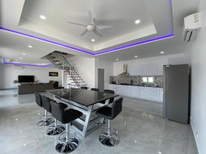 a kitchen with a black table and black chairs at PATTAYA POOL VILLA 428 nearby WALKING STREET in Pattaya South