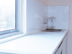a kitchen counter with a sink and a window at Genesis villa in Guwahati +30 photos