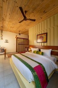a bedroom with a large bed with a ceiling at Tree of Life Ecotainers Agra in Agra